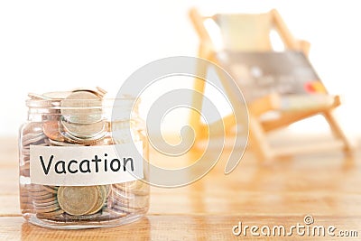 Vacation budget concept. Holidays money savings concept. Collecting money in the money jar for Vacation. Money jar with coins. Stock Photo