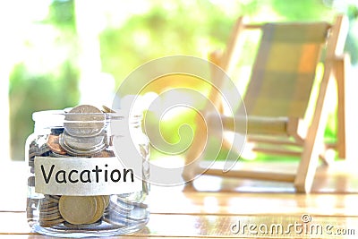 Vacation budget concept. Vacation money savings concept. Collecting money in moneybox for Vacation. Money jar with coins and beach Stock Photo