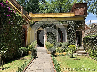 vacation in an eco hotel in forest. summer travel outside. architectural building in nature in flowers and greenery. cozy house Editorial Stock Photo