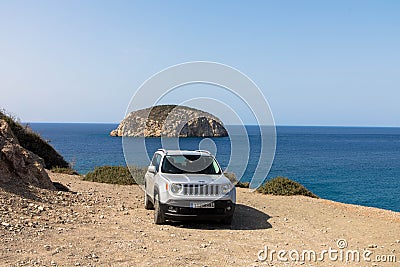 A white Jeep Renegade parked on a dirt road, in the countryside. Four-wheel drive. Editorial Stock Photo