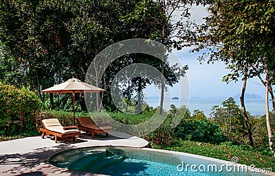 Vacation tropical resort villa infinity pool, beach bed in Phuket Thailand Editorial Stock Photo