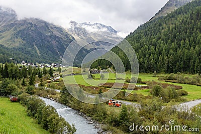 Vacationers stop with their vintage vehicle on the banks of the river that runs through the village of Solda, Ato Adige, Italy Stock Photo