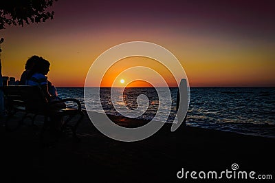 Vacationers On The Sunset Shore Editorial Stock Photo