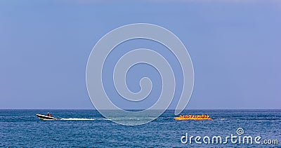 Vacationers tourists ride an inflatable banana in the sea Stock Photo