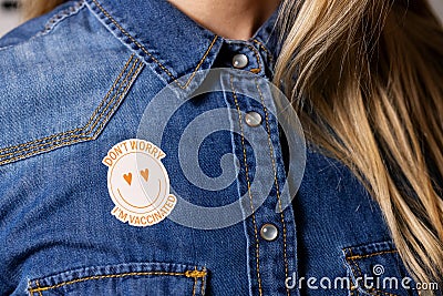 Vaccinated person with immunity identification label on the shirt Stock Photo