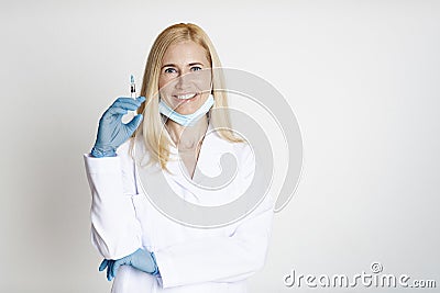 Vaccination, female doctor holding syringe with injection Stock Photo