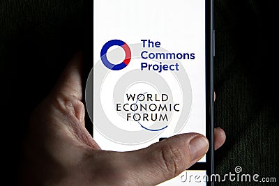 Vaccine passport app company logo displayed on a smartphone next to world economic forum logo. Editorial Stock Photo