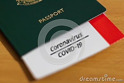 Vaccine Passport Concept. COVID-19 vaccination proof on a card tucked inside the passport Stock Photo