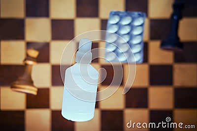 Vaccine pills and retro chess board with chess pieces, king and queen. Concept of problems of intellectual game, politics and Stock Photo