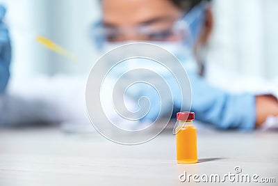 Vaccine stand in front of doctor the pipette and drop the yellow chemical liquid into a petri dish for research and analysis for Stock Photo