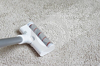 Vacuum cleaner head on dirty carpet with clean strip. Housework with using hoover. Turbo brush of modern vacuum cleaner close up Stock Photo