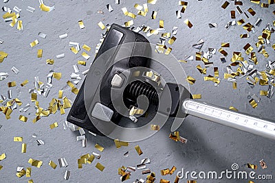 Vacuum cleaner removes confetti. The party is over Stock Photo