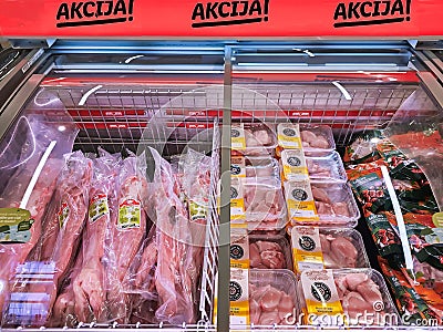 Vacuum-packed fresh rabbit meat and frozen beef steaks with promotional discounts Editorial Stock Photo