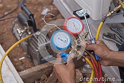 Vacuum pump evacuates air from the air conditioner Stock Photo