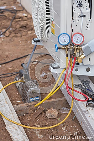 Vacuum pump evacuates air from the air conditioner Stock Photo