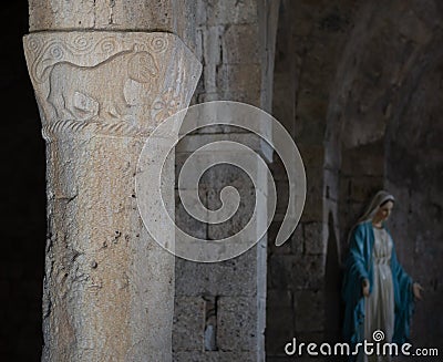 VAGLI SOTTO, LUCCA, ITALY AUGUST 9, 2019: An ancient pillar carving in the small church of St Augustine which dates back Editorial Stock Photo