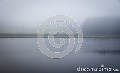 Vague misty and mysterious landscape with channel and grass river bank Stock Photo