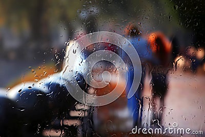 Vague silhouette of two people through rainy glass Stock Photo