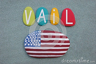 Vail, Colorado, USA, souvenir composed with hand painted multi colored stone letters over green sand Stock Photo