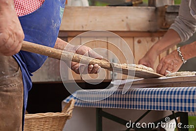 VAL DI FUNES, ITALY - OCTOBER 01, 2016: Traditional Rye flour bread cooked on site during the Editorial Stock Photo