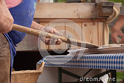 VAL DI FUNES, ITALY - OCTOBER 01, 2016: Traditional Rye flour bread cooked on site during the Editorial Stock Photo