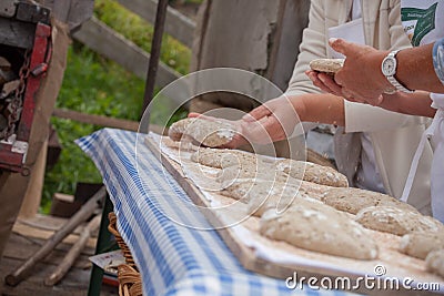 VAL DI FUNES, ITALY - OCTOBER 01, 2016: Traditional Rye flour bread cooked on site during the Editorial Stock Photo