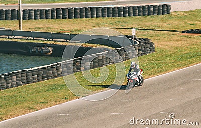 VALENCIA, SPAIN - Dec 06, 2020: White Biker Drives Motorcycle on the Circuit at High Speed Editorial Stock Photo