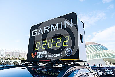 Valencia, Spain - December 3, 2022: Garmin sponsors the timing of the Valencia marathon, with digital clock on a car Editorial Stock Photo