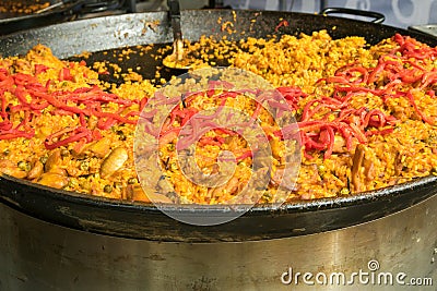 Valencian rice dish, Chicken paella garnished with seared red be Stock Photo