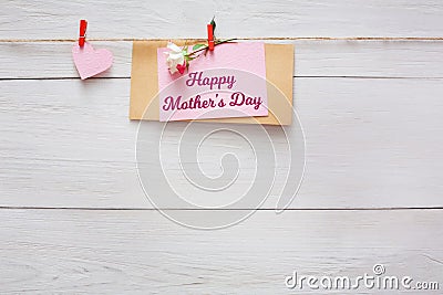 Mothers day background, heart and paper card on clothespins at wooden pillow hearts border on wood, copy space Stock Photo