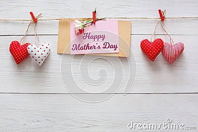 Mothers day background, heart and paper card on clothespins at wooden pillow hearts border on wood, copy space Stock Photo