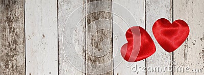 Valentine banner with red silk hearts on wooden planks background Stock Photo