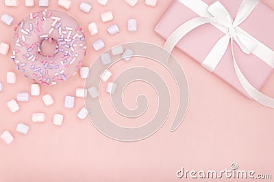 Valentine or birthday day top view composition pink gift with sweet dessert donut and marshmallow on coral paper background. Stock Photo