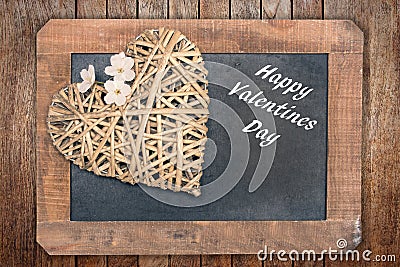 Valentine card, wooden heart with cherry tree flower and vintage blackboard Stock Photo