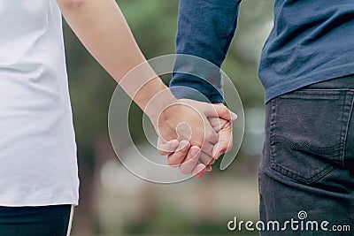 Valentine couples walk hand in hand along the aisles to see the beautiful scenery on the morning of Valentine`s Day and promise t Stock Photo