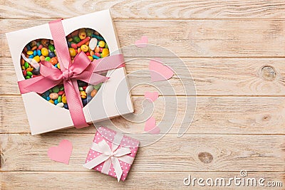 Valentine day composition: sweet candy, with gift boxes with bow and red felt hearts, photo template, background. Top Stock Photo