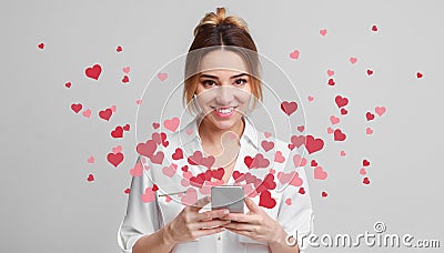 Love message for Valentine day - hearts flying out smartphone in girls hands Stock Photo