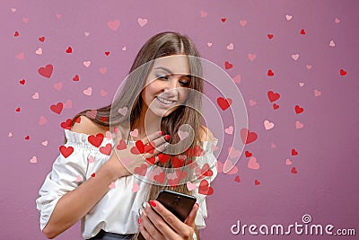 Valentine day concept, love message - hearts flying out smartphone in young, slim womans hands Stock Photo