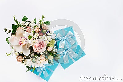 Valentine Day or Mother Day concept. Flower bouquet with gift on white background. Flat lay top view floral composition Stock Photo