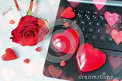 Valentine Day online Shopping. Online communication, virtual love. Laptop, red hearts, red rose. Romantic shopping Stock Photo