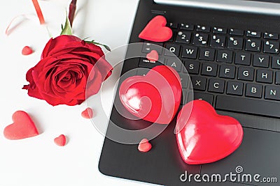 Valentine Day online Shopping. Online communication, virtual love. Laptop, red hearts, red rose. Romantic shopping wedding, women Stock Photo