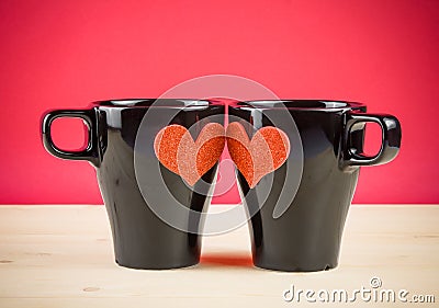 Valentine day series, cups of milk with decorative heart on wood table and red background Stock Photo