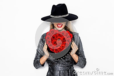 Valentine elegant girl with red heart isolated on white background. Beautiful Happy Young woman with heart of roses. Holiday party Stock Photo