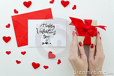 Valentine 14 february hand lettering greeting card. gentle composition for Valentine`s day woman hands holds gift box Stock Photo