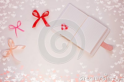 Valentine flatlay. Blank diary, pink heartshaped beads, hearts and ribbon on white background.Notebook mockup,cute style Stock Photo