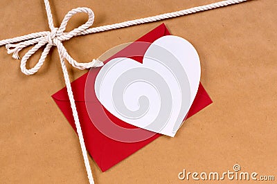 Valentine gift, white heart card, red envelope, brown paper Stock Photo