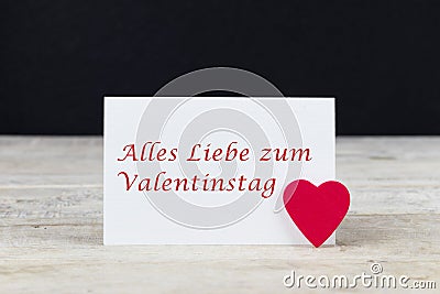 Valentine greeting card on wooden table with text Alles Liebe zum Valentinstag, written in German, which means Happy Valentine d Stock Photo