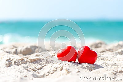 Valentine and Marry Concept. Two red hearts couple lovers for married on the sand summer beach, Stock Photo