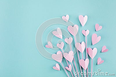 Valentine or Mother day greeting card. Bouquet of paper pink hearts on blue background top view. Flat lay Stock Photo