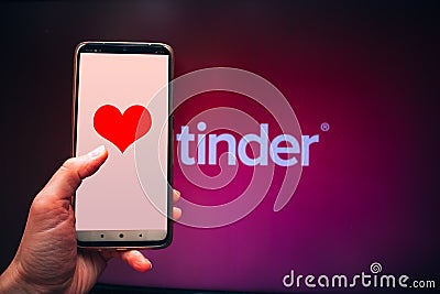 Valentine`s day, Applications for online dating, Phone in hand with a heart on the screen against Editorial Stock Photo